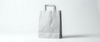 White paper shopping bag with handles standing on clean surface against neutral background for retail branding and packaging design mockups.