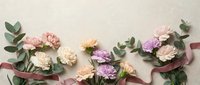 Elegant carnation flowers in soft pink and purple tones with eucalyptus leaves arranged on neutral background for wedding invitations and greeting cards.