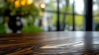 Empty wooden table surface with blurred cafe or restaurant interior background with warm bokeh lights, suitable for product display or montage.