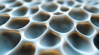 Macro view of honeycomb-like structure with circular holes creating abstract geometric pattern in blue and brown tones, showing depth and repetitive shapes.