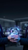 Two business professionals in suits holding a glowing holographic factory icon, symbolizing industrial partnership and smart manufacturing innovation.
