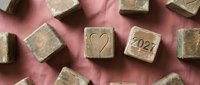 Wooden blocks with heart symbol and 2027 date on pink background, representing new year planning, goals, and future aspirations for design projects.