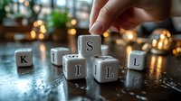 White letter cubes spelling skills on dark reflective surface with soft bokeh lights and hand arranging letters, conceptual business and education scene.