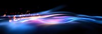 Glowing abstract waves with pink and blue light trails against black background create dynamic motion effect for technology and energy designs.