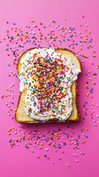 Colorful sugar sprinkles on white cream spread over toasted bread slice against vibrant pink background, playful food styling for dessert and breakfast concepts.