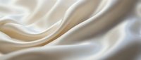 Smooth cream silk fabric with soft folds and luxurious sheen, suitable for fashion, textile, and luxury product backgrounds.