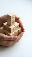 Hands cupping wooden blocks engraved with medical symbols, heart, cross, and caduceus, representing healthcare protection and wellness concepts.