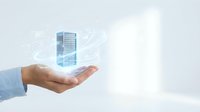 Male hand holding a glowing holographic server tower with digital network lines, symbolizing cloud computing and data center management.
