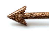 Rustic wooden arrow pointing left carved from natural wood branch on white background, showing organic texture and directional symbol for design projects.