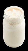 Creamy cappuccino in glass jar with latte art foam top, isolated on transparent background. Ready for beverage, cafe, and food design projects.