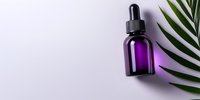 Purple glass dropper bottle with palm leaf on white background, minimalist spa and wellness composition for aromatherapy and essential oils packaging.