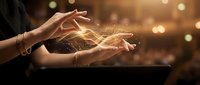 Woman's hands releasing glowing golden light particles and sparks, symbolizing magic, energy, healing, and spiritual power for wellness and transformation concepts.