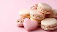 Sweet heart-shaped and round macarons in delicate pink and cream colors arranged on pink background, fresh French pastry confection for romantic occasions.