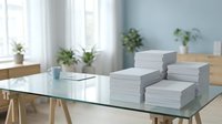 Stacks of white paper documents organized on modern glass desk in bright office workspace with plants and natural lighting for business productivity.