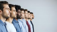 Diverse group of professional men standing in profile line looking forward with determination and focus for business teamwork and leadership concepts.