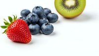 Fresh mixed berries and kiwi slice on white background. Healthy organic fruit selection for smoothies, breakfast bowls and nutritious snacking.