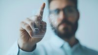 Bearded Caucasian businessman interacting with futuristic holographic interface displaying analytics and data visualization elements in modern office setting.