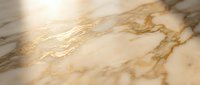 Luxurious golden marble surface with elegant veining patterns and warm lighting creating sophisticated texture for interior design and architectural projects.