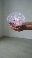 Hands holding a glowing holographic neuron network, symbolizing brain science, AI, and neural technology innovation in medicine and research.