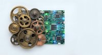 Vintage brass mechanical gears and modern green circuit board representing evolution from analog to digital technology on white background.