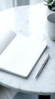 Blank notebook with silver pens on marble desk beside coffee cup and potted plant, ready for writing, planning, or business use.