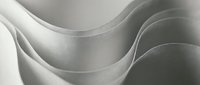 Smooth curved layers of white and gray material creating flowing, undulating waves with soft shadows and highlights throughout the composition.