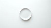 Empty white ceramic plate on clean white background for kitchen and dining design projects.