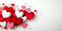Paper cut hearts in red, pink and white colors scattered on light background with confetti dots for Valentine's Day greeting cards and romantic designs.