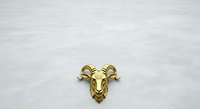 Golden goat head sculpture isolated on white background, ready for design projects, wall decor, and branding applications.