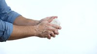 Man washing hands with soap and water, thorough cleaning technique for hygiene and health protection against germs and bacteria on white background.