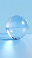 Transparent glass sphere with water on light blue background, creating refraction and soft shadows for cosmetic or scientific concepts.