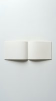 Open blank notebook with empty white pages on neutral background for writing, journaling, education and creative projects.