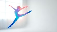 Colorful gradient silhouette of female dancer performing grand jete leap in bright studio space for creative design projects.