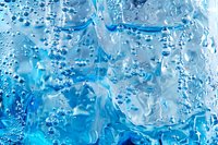 Fresh water drops and bubbles on blue glass surface create dynamic abstract pattern with light refraction and condensation effects for backgrounds.