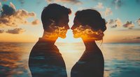 Silhouettes of romantic couple against golden sunset sky and ocean backdrop, double exposure effect creates dreamy atmosphere for wedding and relationship themes.