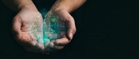 Male hands cupping glowing digital Earth globe with network connections and data visualization effects against dark background for technology concepts.