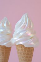 Iridescent soft serve ice cream cones with holographic swirl topping on pink background for summer dessert and food photography concepts.