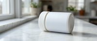 White supplement bottle with blank label on marble kitchen counter for pharmaceutical branding and health product marketing campaigns.