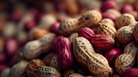 Mixed nuts and peanuts in shells creating colorful natural texture for healthy snacking and cooking ingredients background.