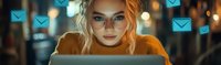 Young woman in glasses working on laptop at night with glowing email icons floating above, depicting digital communication and remote work in modern lifestyle.