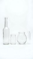 Empty glass bottles and jars collection isolated on white background for packaging design and craft projects.