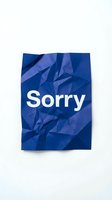 Crumpled blue paper with white Sorry text on white background, conveying apology, regret, and forgiveness concepts for social media.