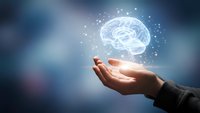 Hand holding glowing brain with neural connections representing artificial intelligence, machine learning, and cognitive technology innovation.