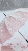 Pink umbrella covered in raindrops against soft background with scattered heart-shaped petals, creating romantic rainy day atmosphere. Wooden handle adds vintage charm.