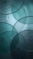 Overlapping translucent circles in teal and blue tones create an abstract composition with layered depth and modern aesthetic appeal for contemporary design projects.