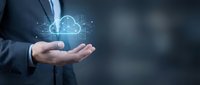 Businessman holding glowing cloud computing icon with network connections. Digital transformation and data storage technology concept for modern business.