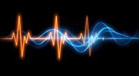 Digital sound wave visualization with glowing orange and blue frequency lines on black background for audio technology and music production.
