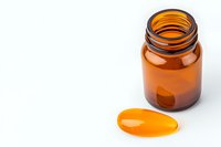 Empty amber glass medicine bottle with liquid gel capsule on white background, pharmaceutical and supplement packaging concept for healthcare industry.