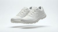 White minimalist trail running sneakers floating on light background, showcasing modern athletic footwear design for sport and lifestyle concepts.