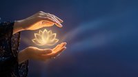 Hands holding glowing lotus flower against twilight sky, symbolizing spirituality, meditation, wellness, and inner peace for mindfulness and healing concepts.